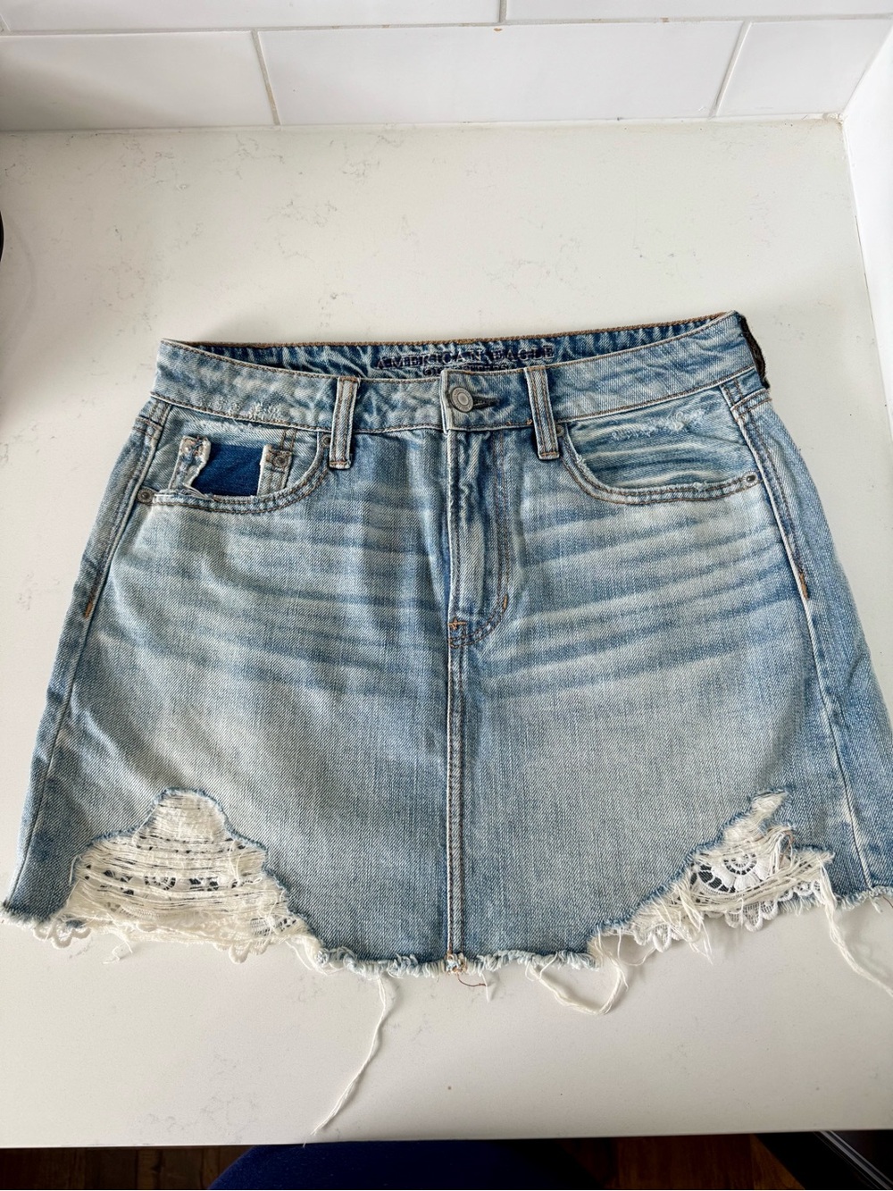 American Eagle Light Wash Distressed Denim Mini Skirt with Lace Trim
